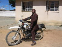 photo of a MuCoBa field officer on his motorcycle